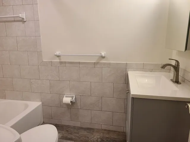 a bathroom with a toilet sink and shower