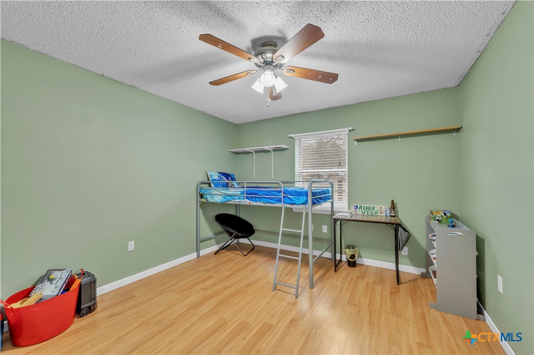 806 County Road 4756 Kempner, TX 76539 - Photo 15 of 33 a bedroom with a bed and a chandelier