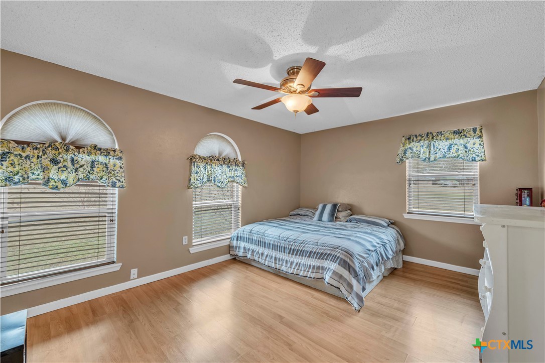 806 County Road 4756 Kempner, TX 76539 - Photo 18 of 33 a bedroom with a bed and a chandelier