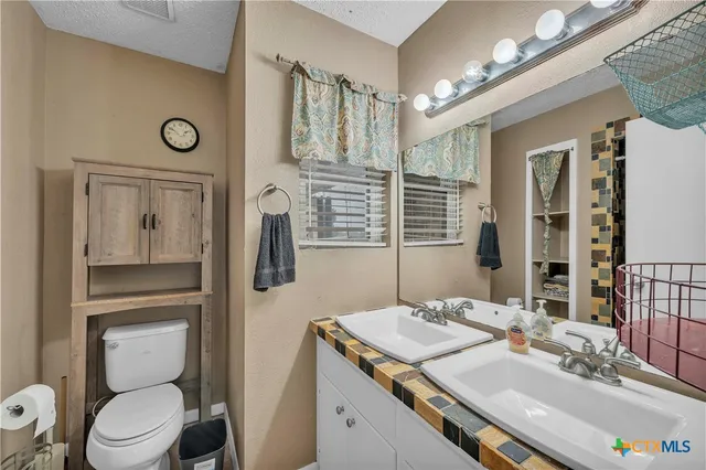 a bathroom with a toilet and a shower curtain