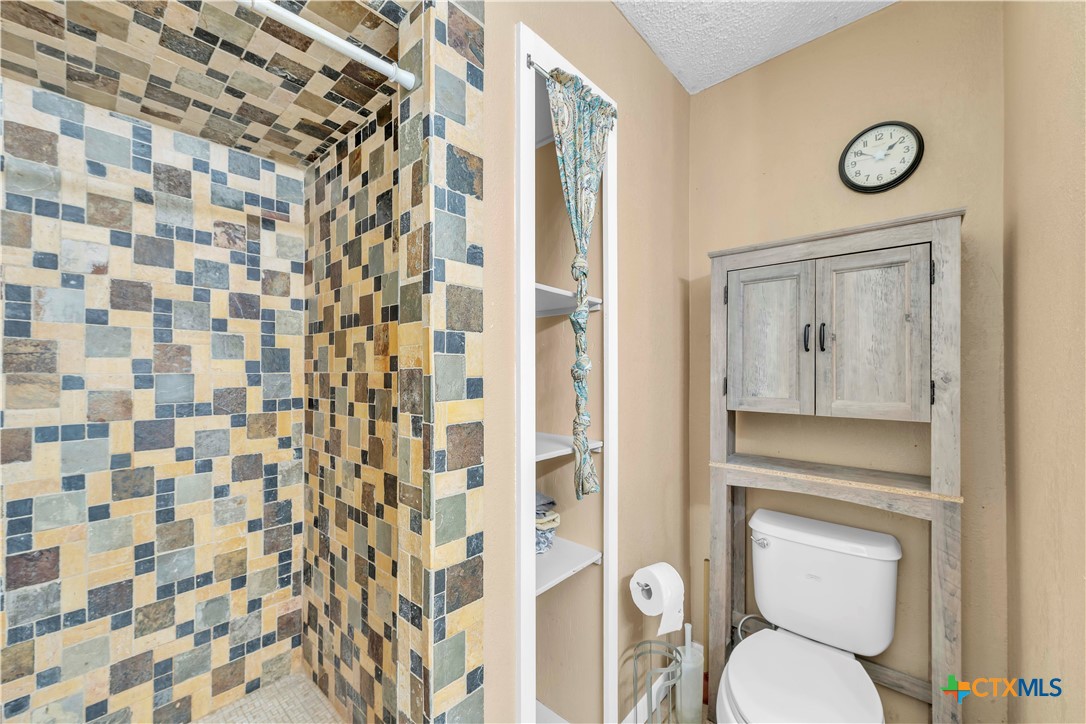 806 County Road 4756 Kempner, TX 76539 - Photo 21 of 33 a bathroom with a toilet and a shower curtain
