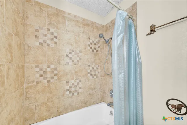 a view of a room with wooden floor and fan