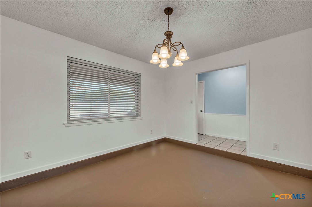 806 County Road 4756 Kempner, TX 76539 - Photo 27 of 33 an empty room with a chandelier fan and windows