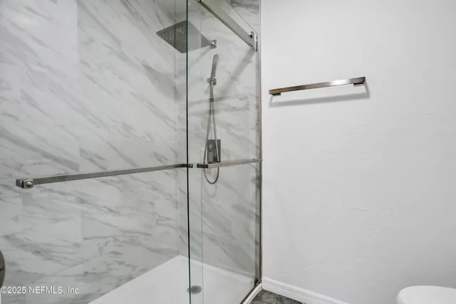 a bathroom with a granite countertop sink a toilet and a mirror