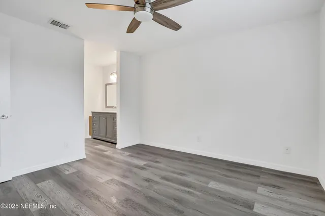 a brick building with a tree in the background