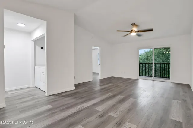 an aerial view of residential houses with outdoor space and street view