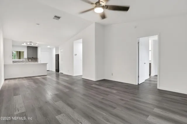 a kitchen with sink a microwave and cabinets