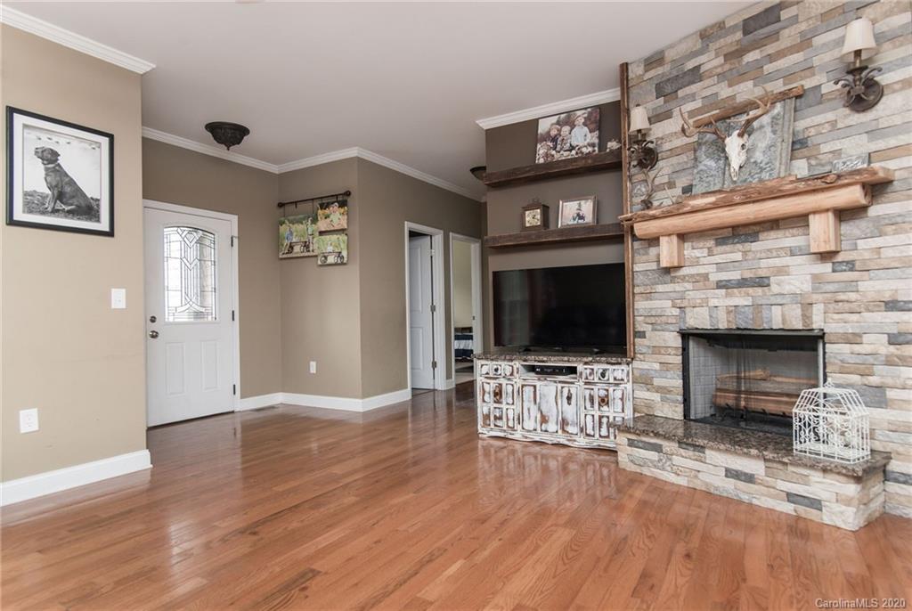 725 Hawley Road McConnells, SC 29726 - Photo 15 of 32 a living room with furniture a flat screen tv and a fireplace