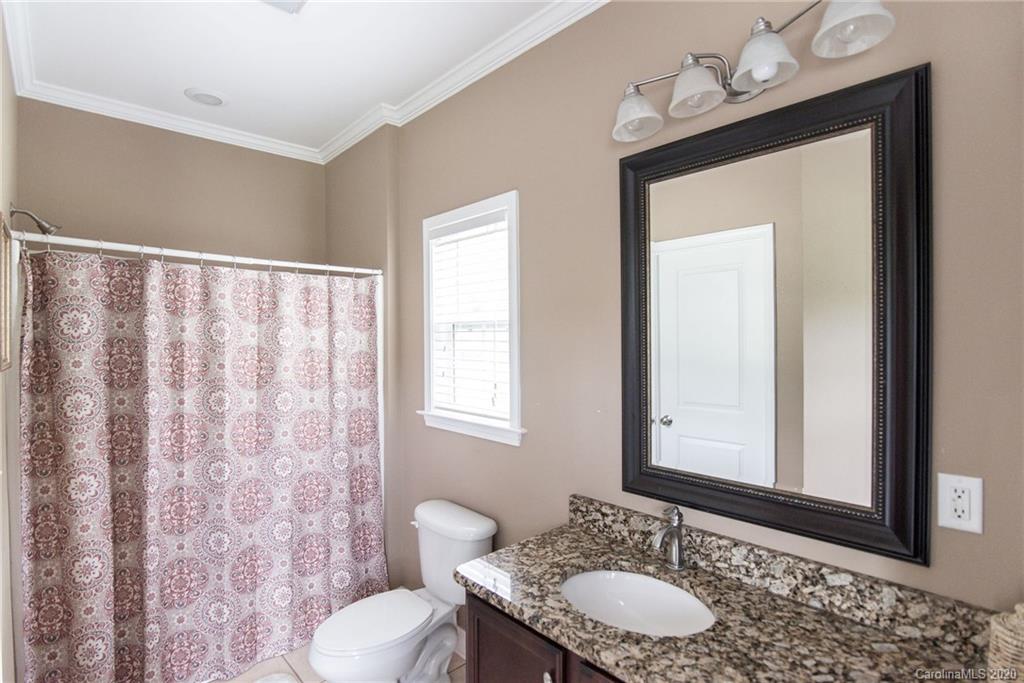 725 Hawley Road McConnells, SC 29726 - Photo 22 of 32 a bathroom with a granite countertop sink and a mirror with toilet