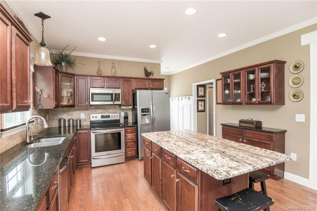 725 Hawley Road McConnells, SC 29726 - Photo 6 of 32 a kitchen with stainless steel appliances granite countertop a sink stove and refrigerator