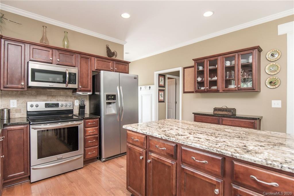 725 Hawley Road McConnells, SC 29726 - Photo 7 of 32 a kitchen with stainless steel appliances granite countertop a stove microwave and refrigerator