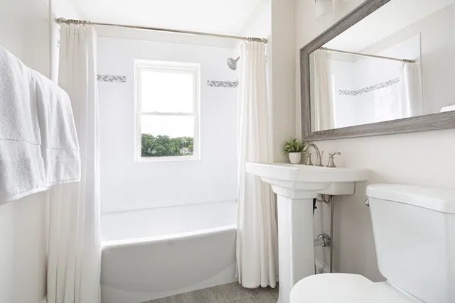 a bathroom with a sink toilet and shower