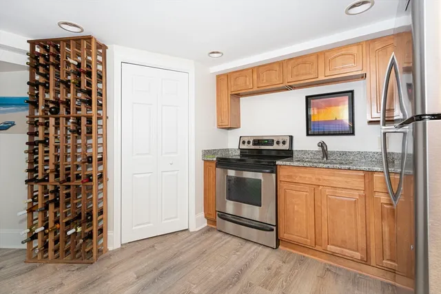 a kitchen with granite countertop a refrigerator and a sink