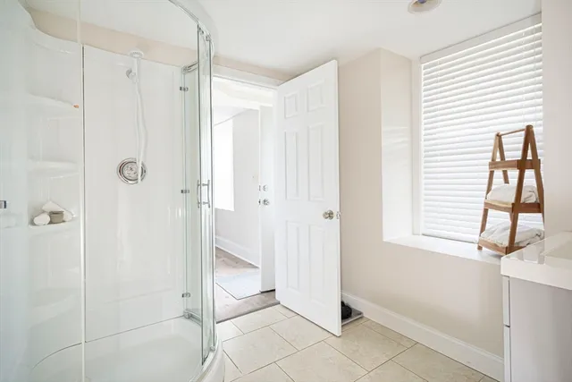 a bathroom with a shower and a sink