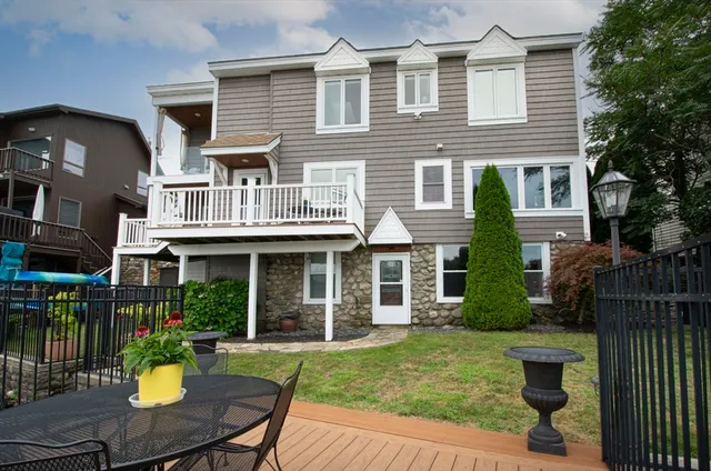 a view of a house with a yard and furniture