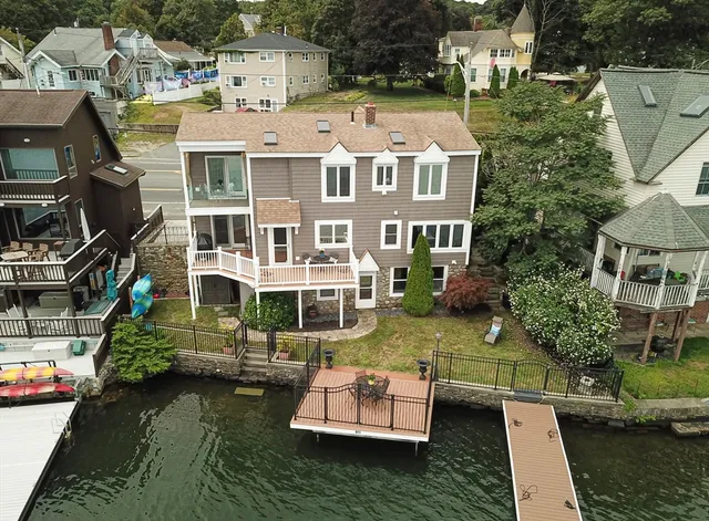 an aerial view of a house with swimming pool and outdoor seating