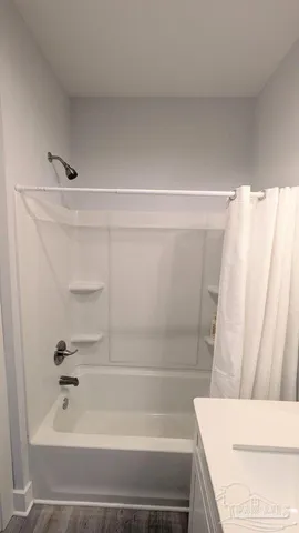a bathroom with a tub and a shower