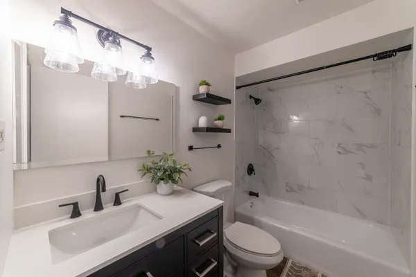 a bathroom with a sink a toilet and a bathtub