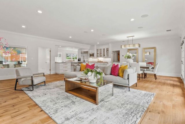 a living room with furniture and kitchen view