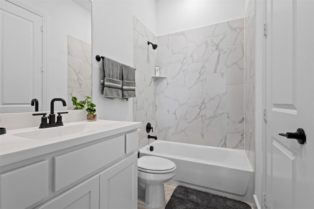 1825 Rough Rdg Trail Midlothian, TX 76065 - Photo 24 of 37 Bathroom featuring a white vanity with integrated sink, black matte faucet, and matching hardware