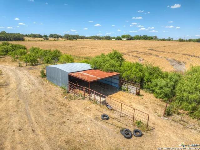 a view of a lake with table and chairs