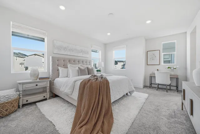 a spacious bedroom with a bed and window