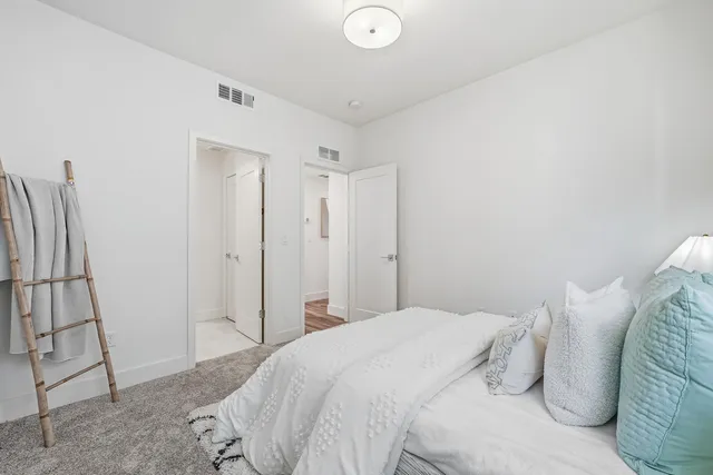 a bedroom with a bed and a sink