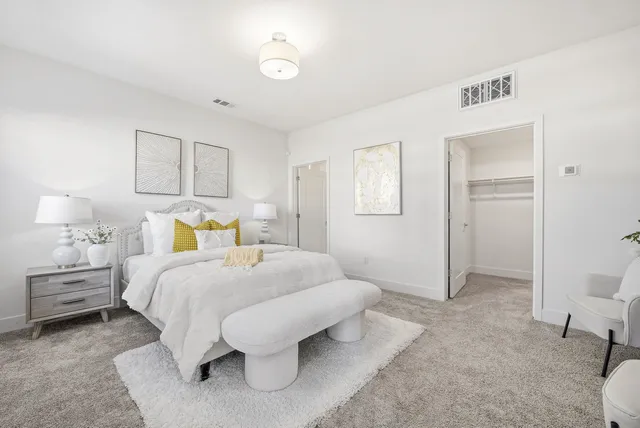 a bedroom with a bed and a lamp