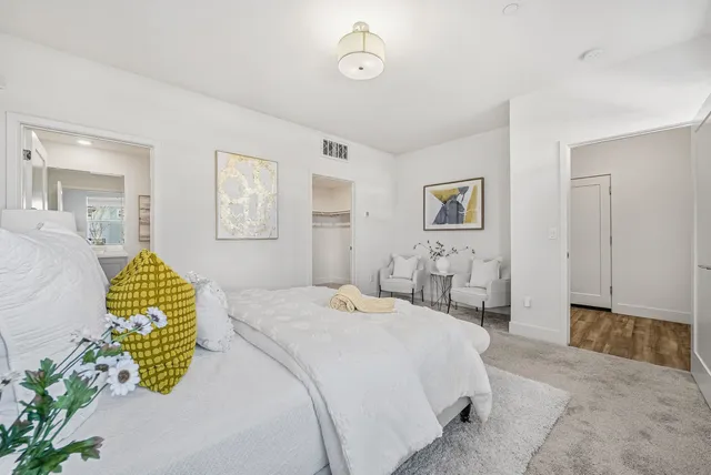 a bedroom with a bed and a chandelier