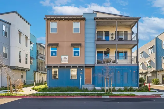 a front view of a residential apartment building with a yard