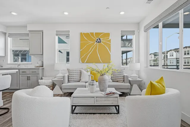 a living room with fireplace furniture and a large window