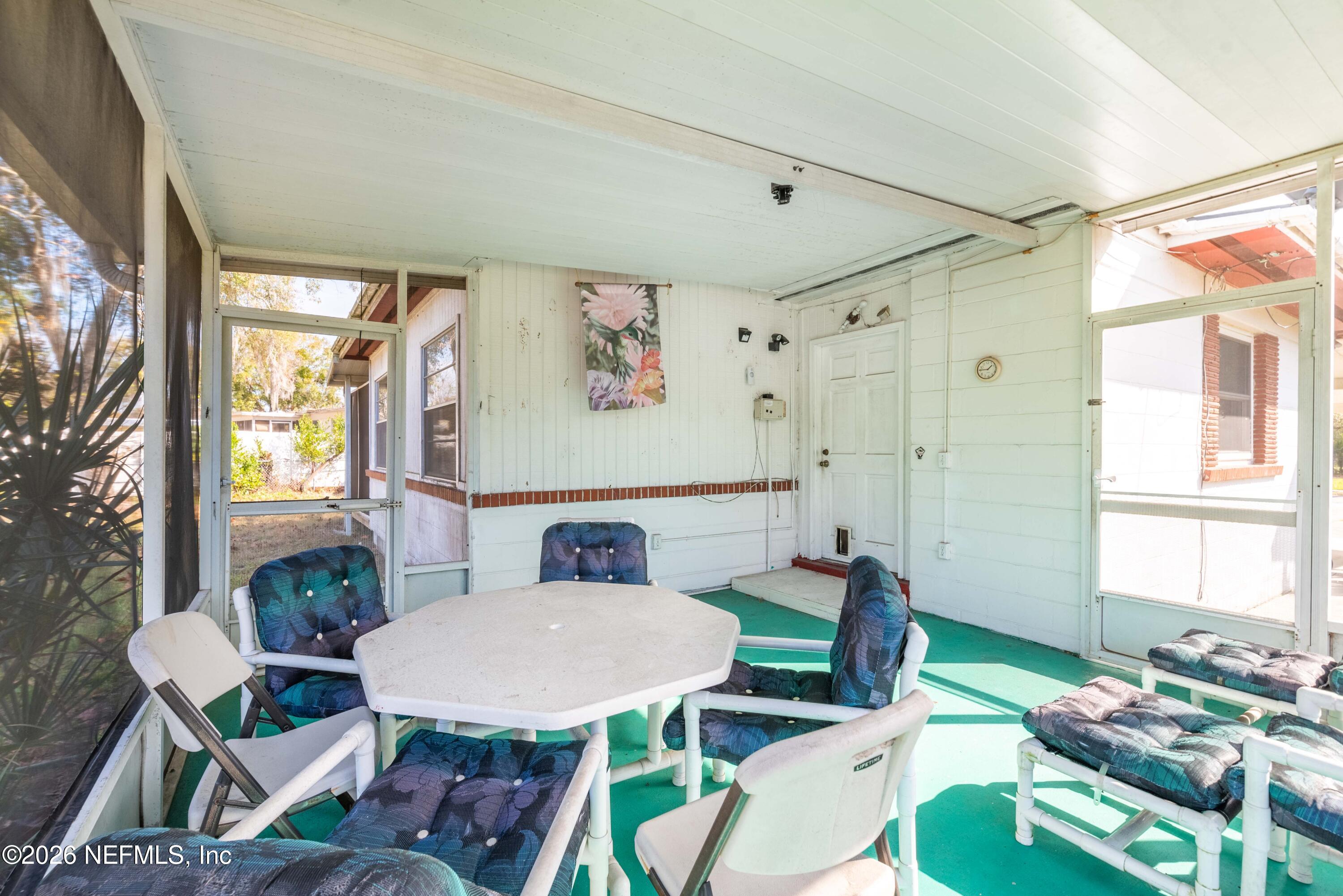 3905 Ferrarra Street Jacksonville, FL 32217 - Photo 21 of 29 a view of a dining room with furniture a rug and wooden floor