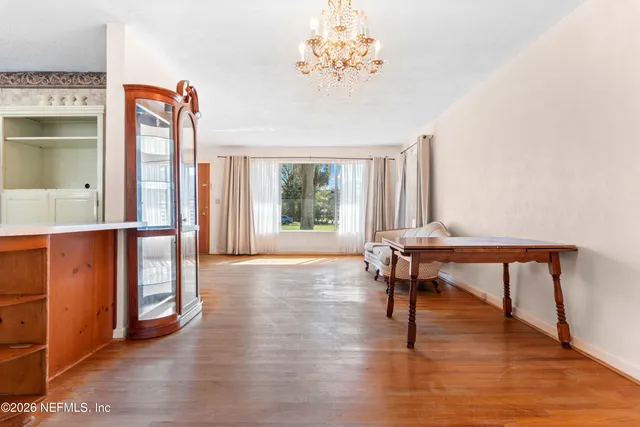 a view of a livingroom with furniture window and wooden floor