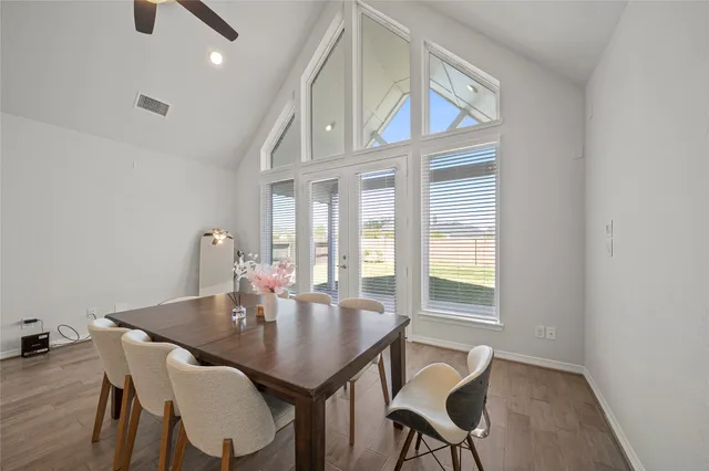 a view of a dining room with furniture and wooden floor