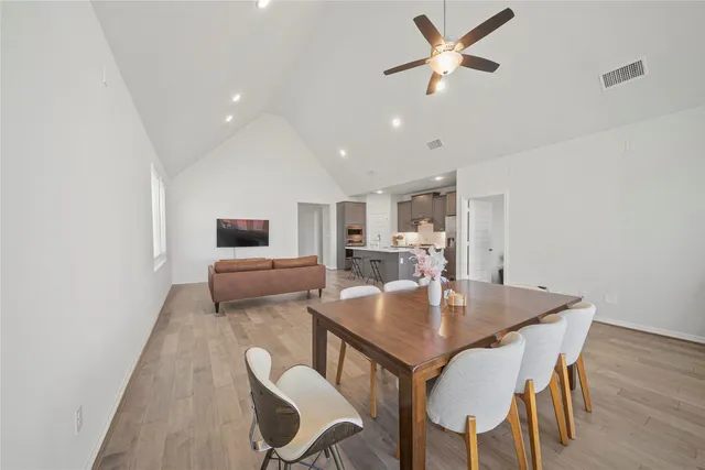 a very nice looking living room with a large window and wooden floor
