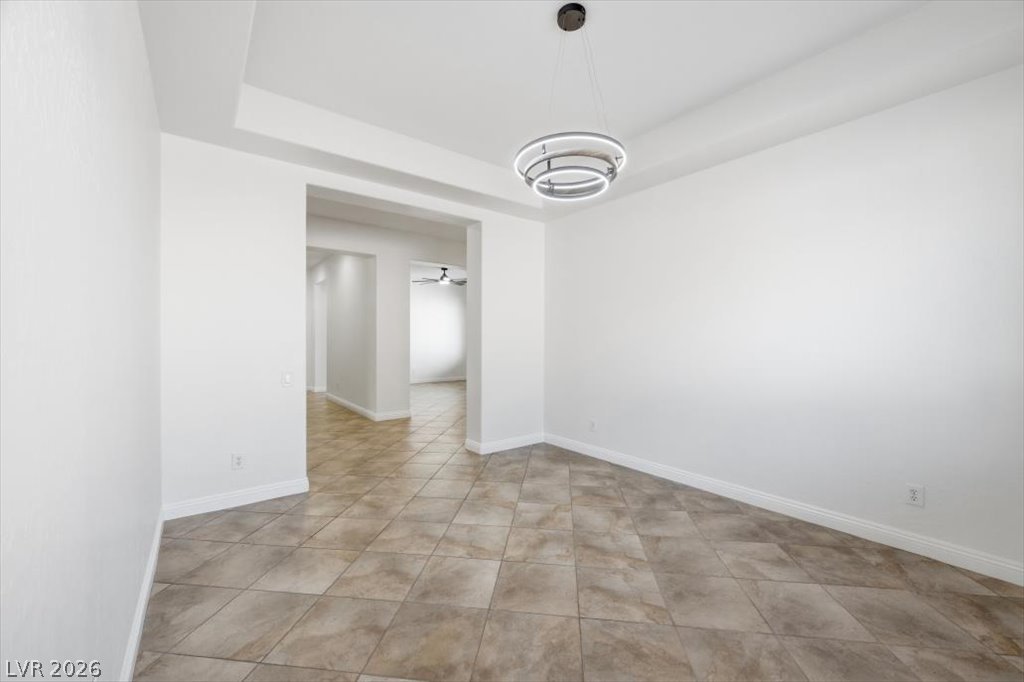 2125 De Rouge Avenue Henderson, NV 89044 - Photo 36 of 96 A well-lit, open interior space featuring sleek tiled flooring and a contemporary overhead light fixture.