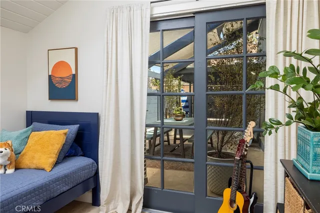 a vase of flowers sitting on a table with window