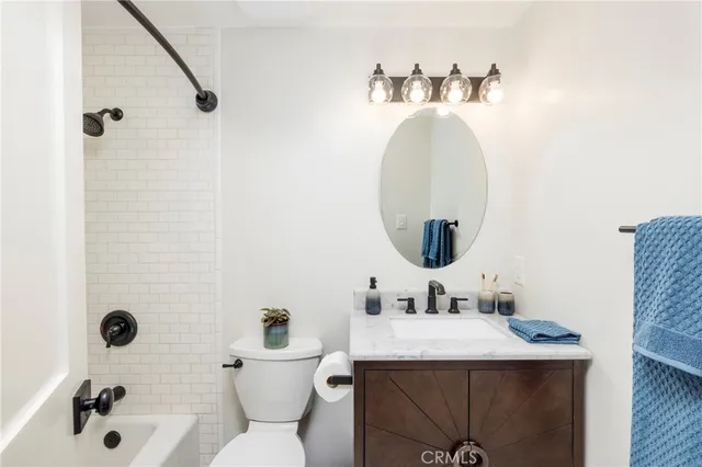 a bedroom with a bed and a potted plant