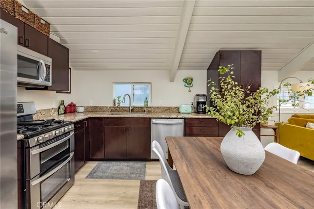 a kitchen with a sink stainless steel appliances and cabinets