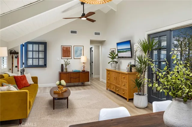 a living room with furniture and a potted plant