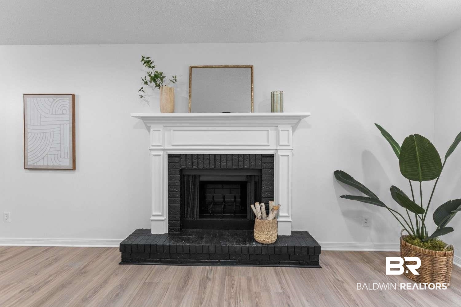 10251 Windmill Road Fairhope, AL 36532 - Photo 18 of 44 Detailed view of wood finished floors and a brick fireplace