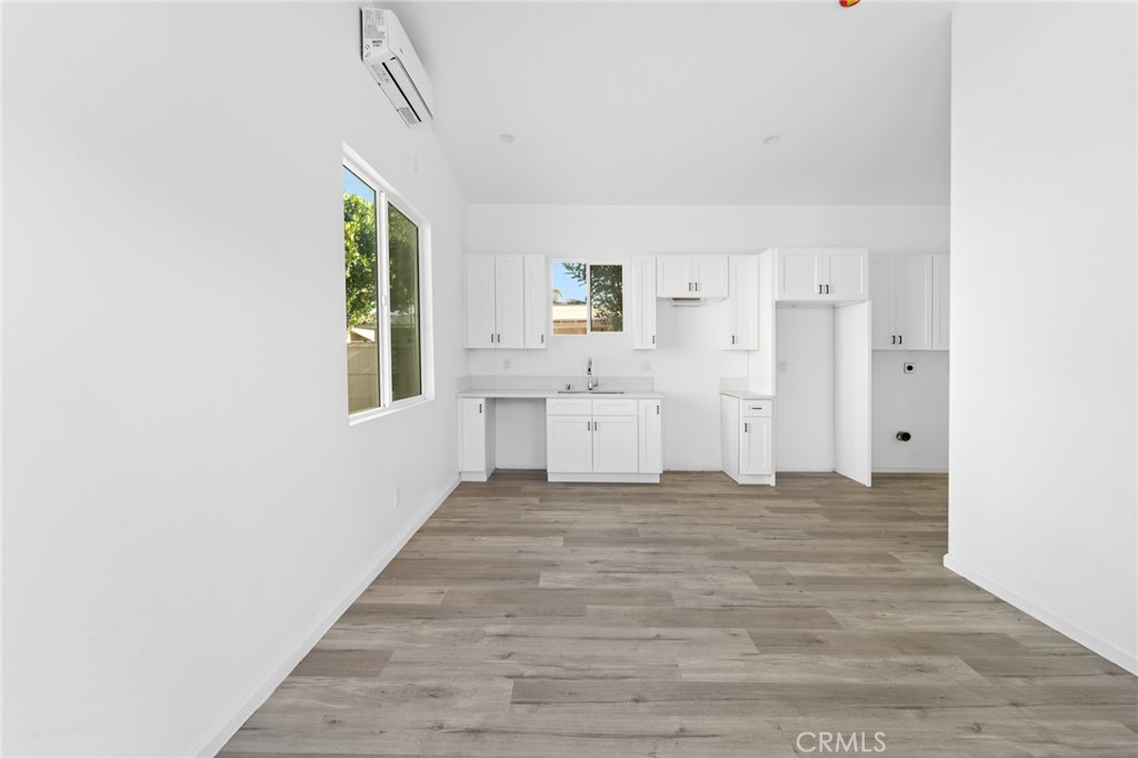 8510 1/2 Wilbur Avenue Northridge, CA 91324 - Photo 2 of 11 a view of a bedroom with wooden floor and windows