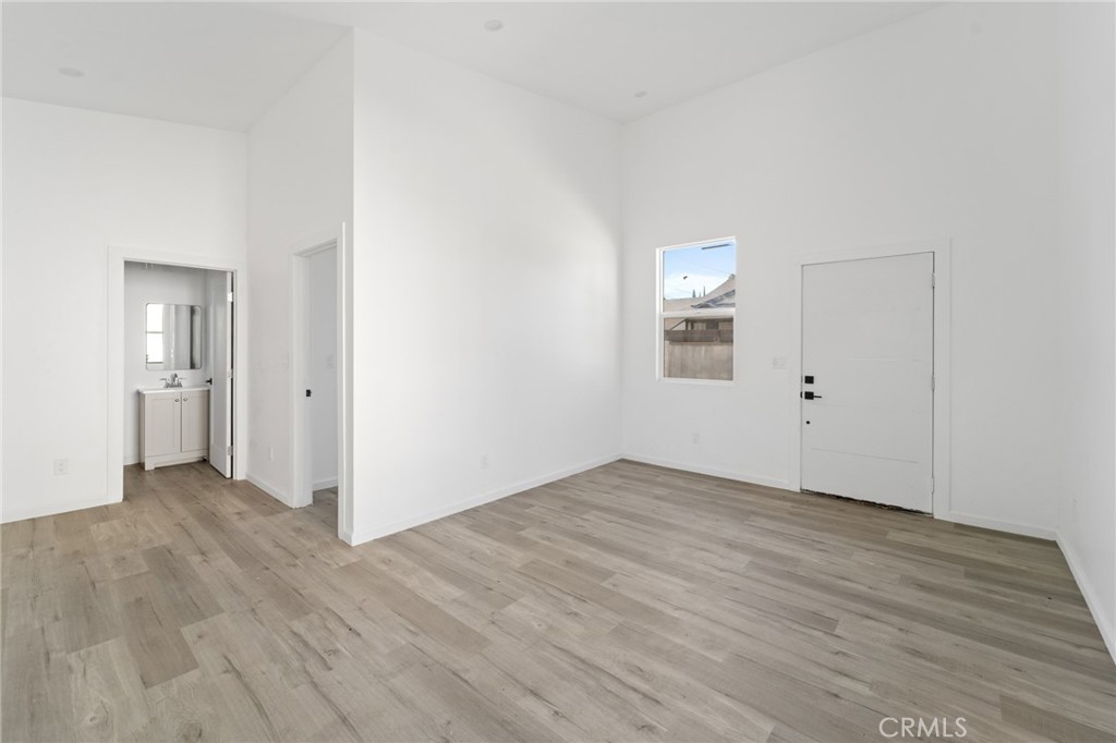 8510 1/2 Wilbur Avenue Northridge, CA 91324 - Photo 3 of 11 an empty room with wooden floor and windows