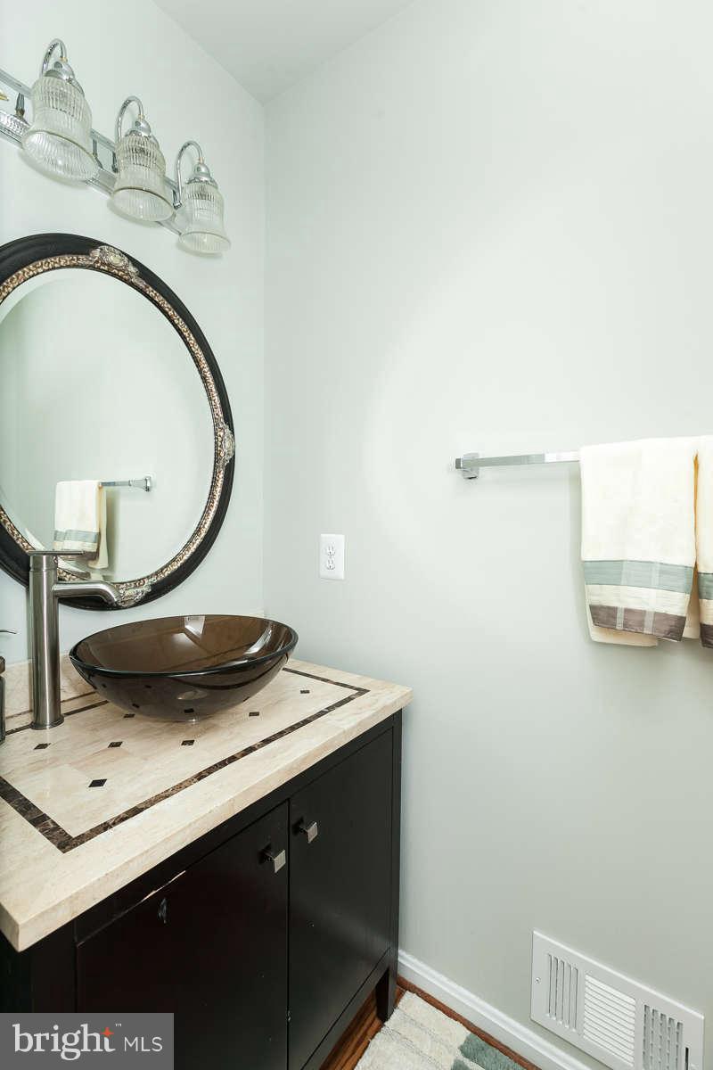 8596 Trail View Drive Ellicott City, MD 21043 - Photo 13 of 29 a bathroom with a sink and a mirror