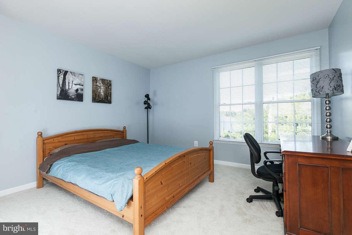 8596 Trail View Drive Ellicott City, MD 21043 - Photo 19 of 29 a bedroom with a bed and a large window