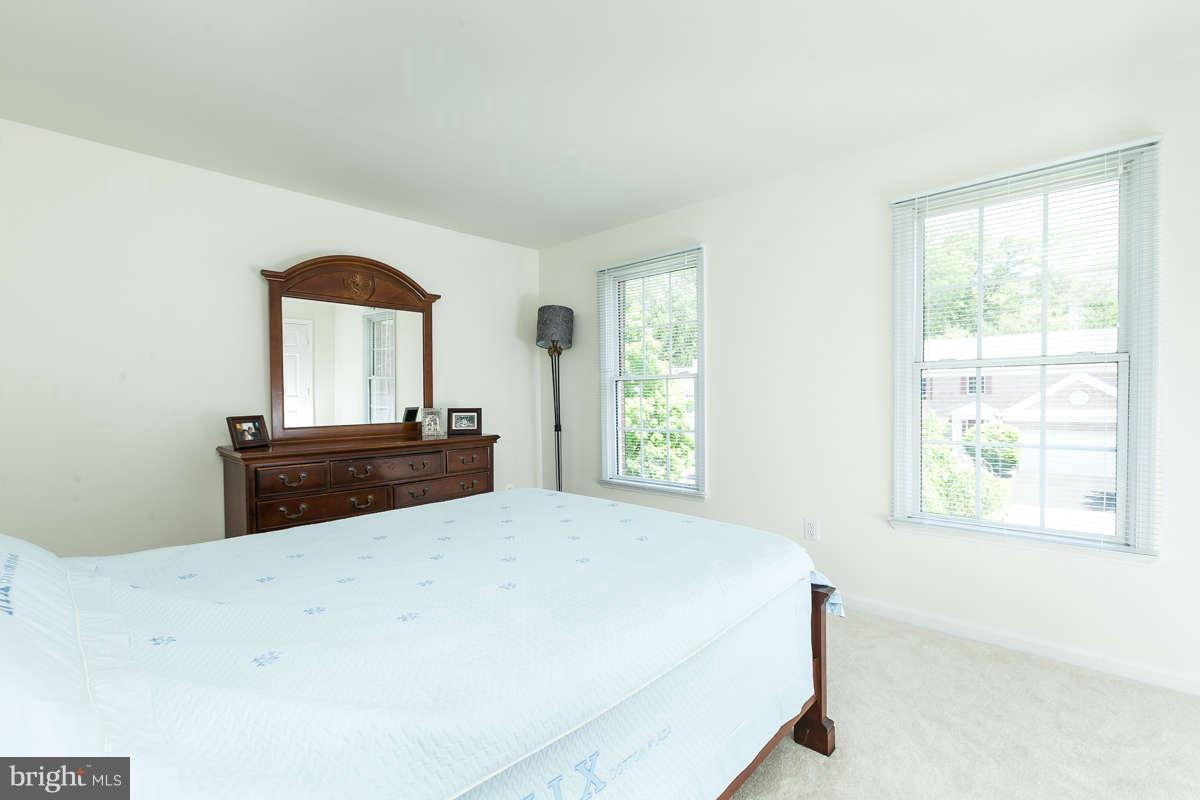 8596 Trail View Drive Ellicott City, MD 21043 - Photo 20 of 29 a room with a bed and a dresser