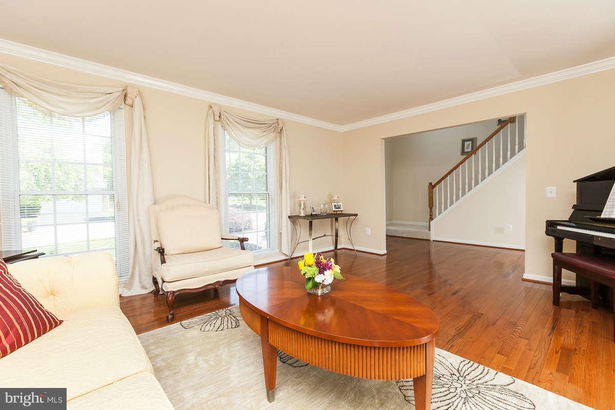8596 Trail View Drive Ellicott City, MD 21043 - Photo 3 of 29 a living room with dining room and wooden floor