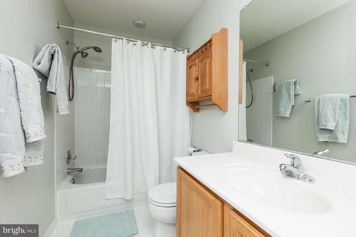 8596 Trail View Drive Ellicott City, MD 21043 - Photo 22 of 29 a bathroom with a sink toilet and shower