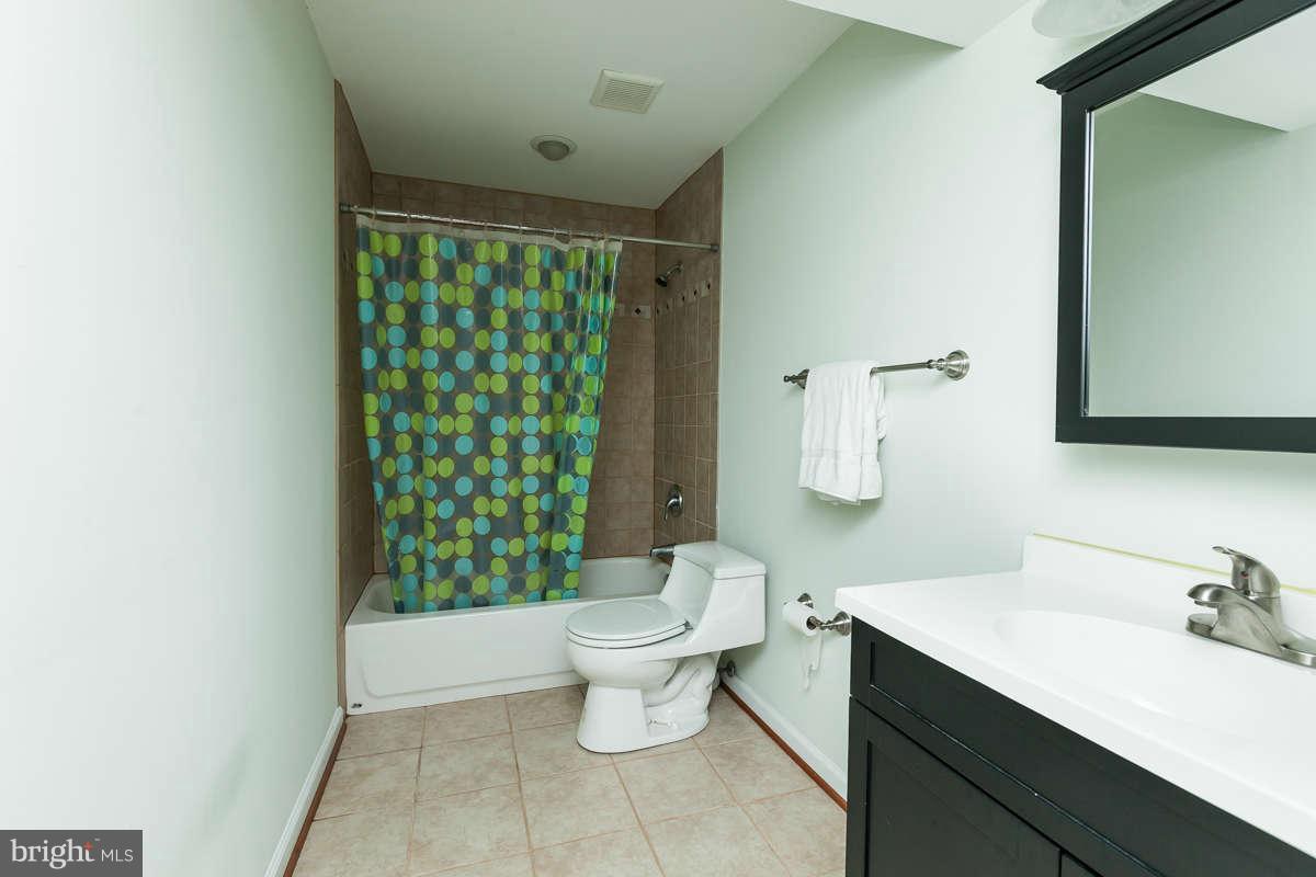 8596 Trail View Drive Ellicott City, MD 21043 - Photo 25 of 29 a bathroom with a sink toilet and shower