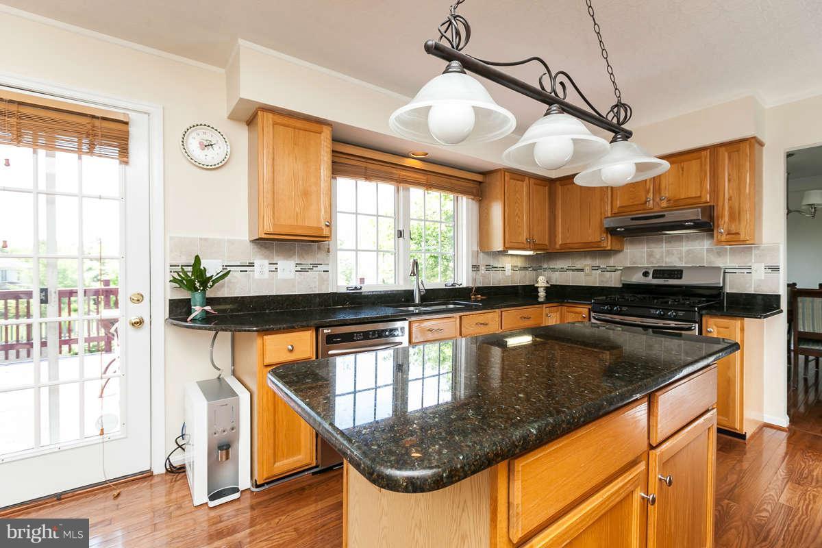 8596 Trail View Drive Ellicott City, MD 21043 - Photo 6 of 29 a kitchen with stainless steel appliances granite countertop a sink a counter space and a window